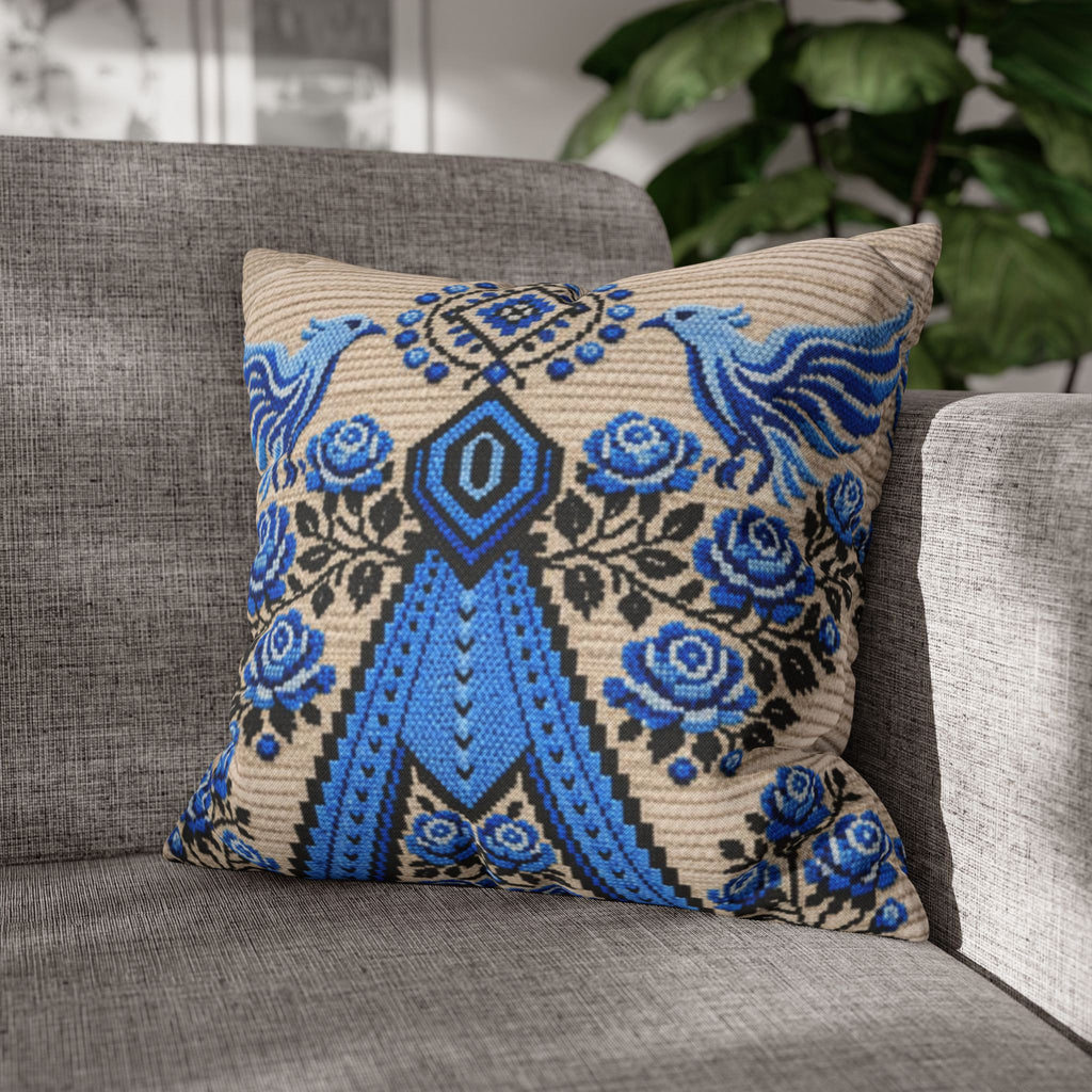 Ukrainian Berehynia throw pillow with blue black folk art pattern on sofa
