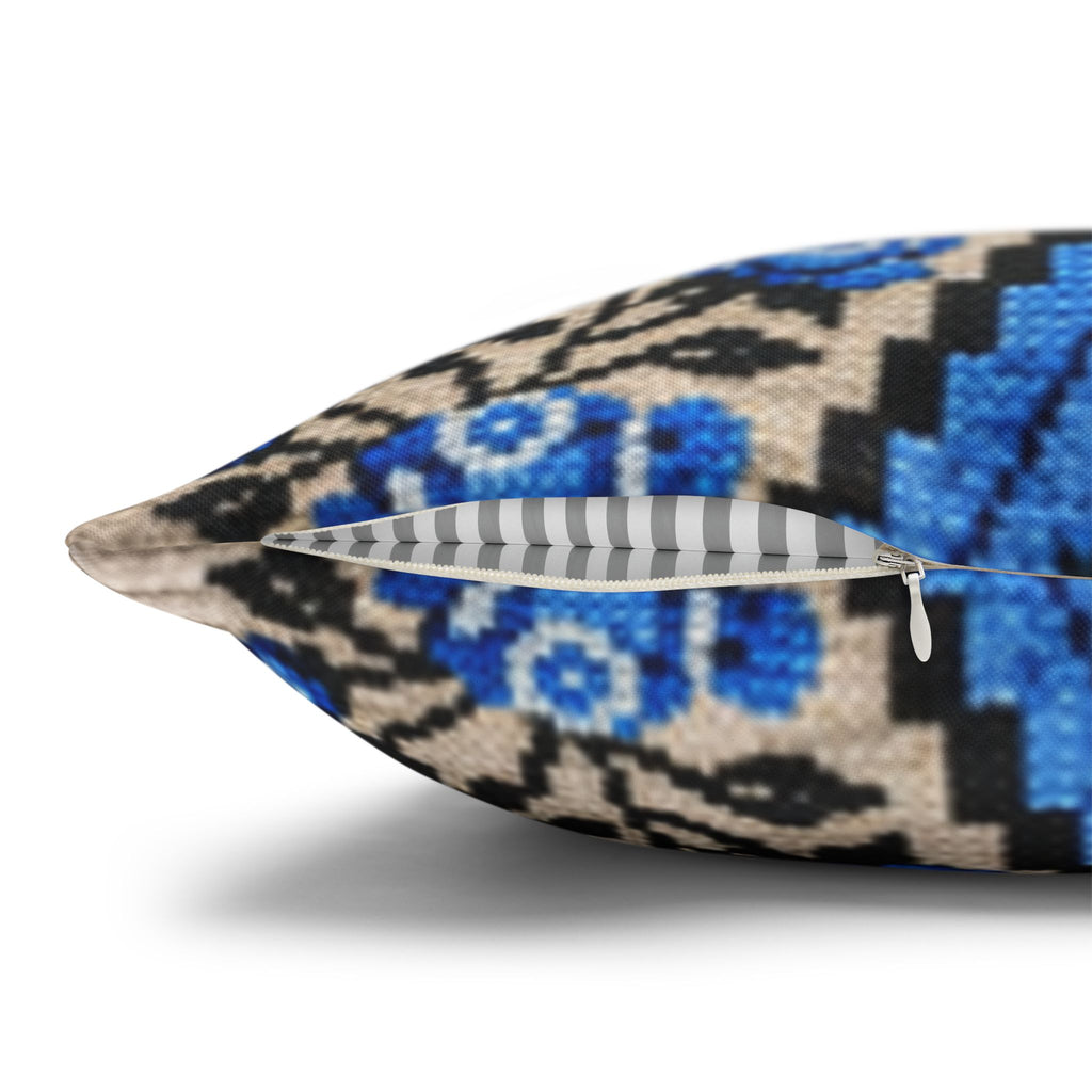 Ukrainian Berehynia throw pillow with blue black folk art pattern on sofa
