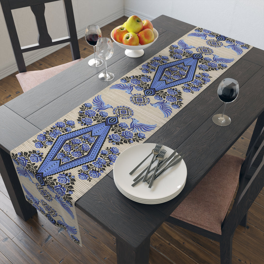 Ukrainian Berehynia table runner with blue black folk art pattern on dining table
