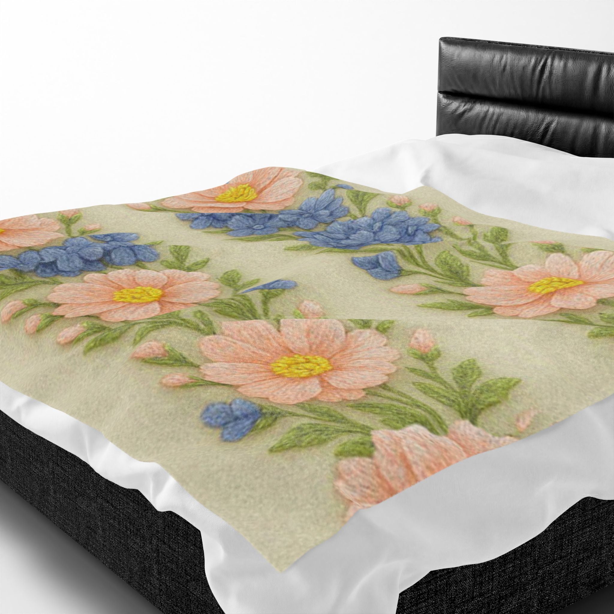 Soft velveteen plush blanket from the Wooly Garden collection with a pink daisy and blue hyacinth floral pattern, featuring a realistic wool embroidery effect.