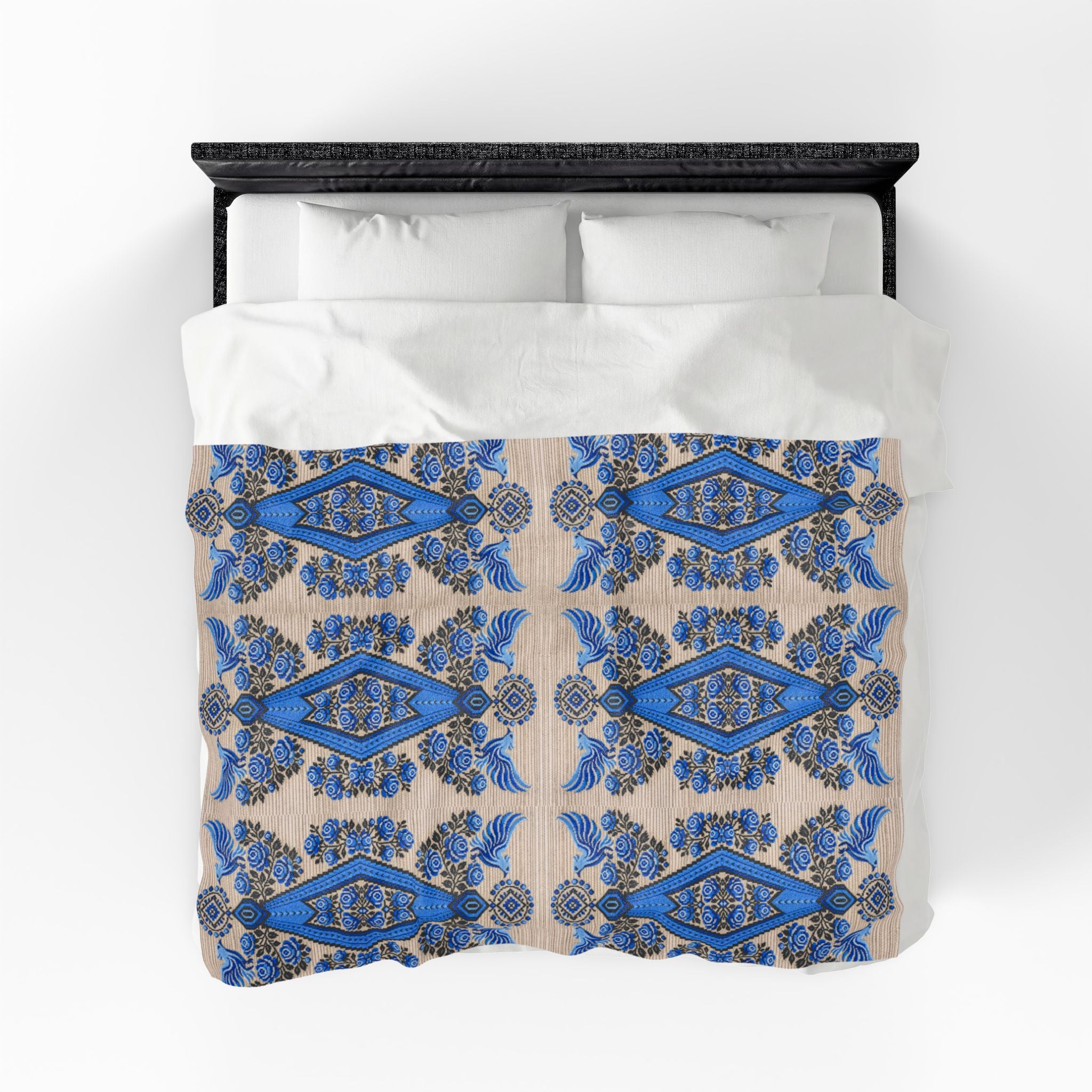 Ukrainian Berehynia blanket with blue black folk art geometric pattern on bed
