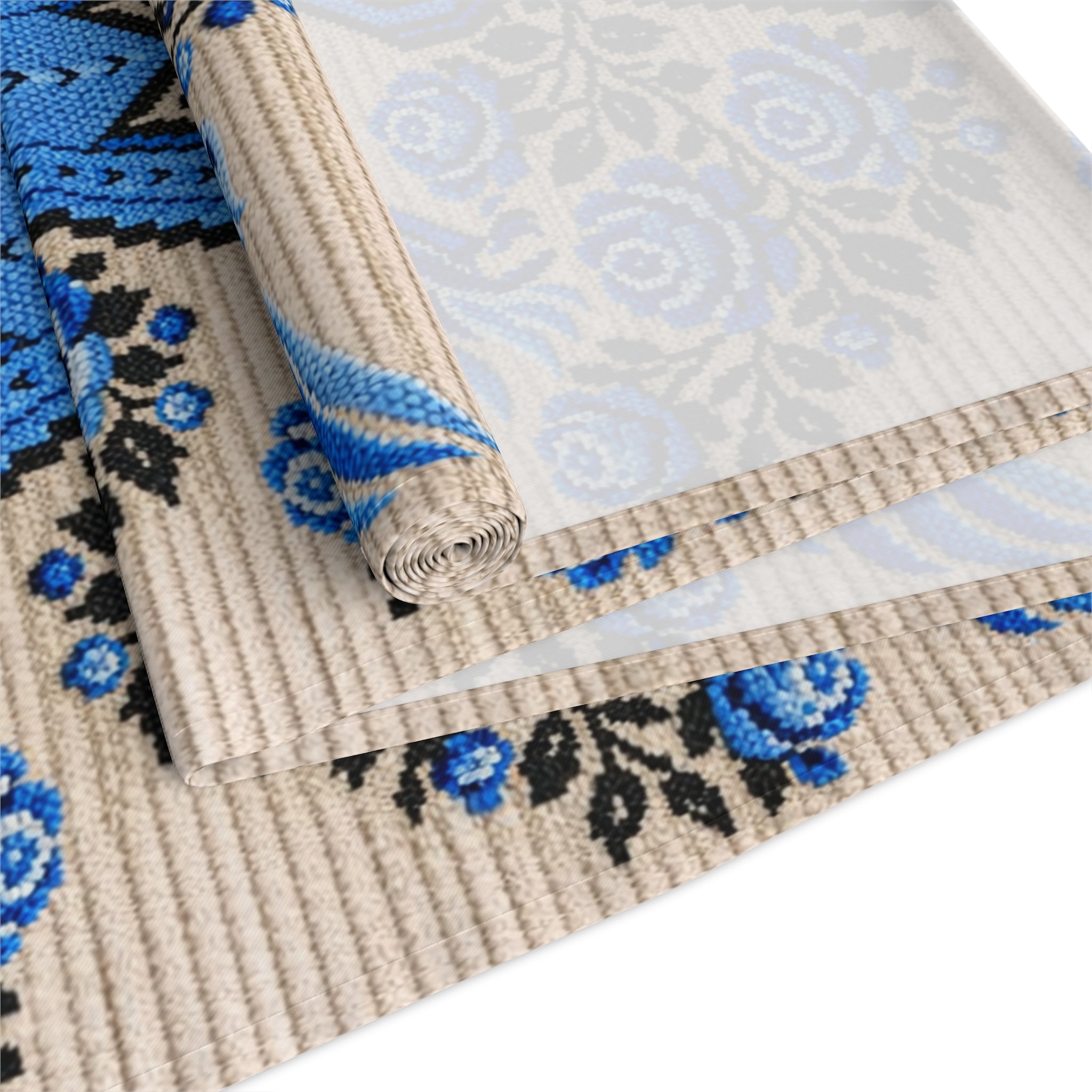 Ukrainian Berehynia table runner with blue black folk art pattern on dining table
