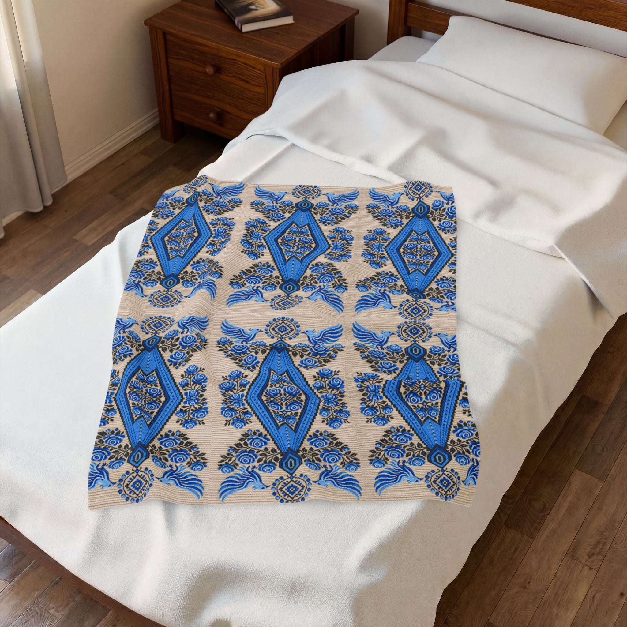 Ukrainian Berehynia blanket with blue black folk art geometric pattern on bed
