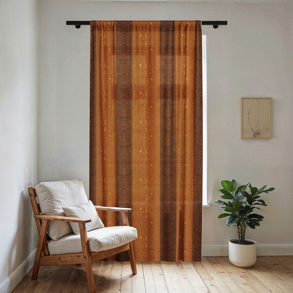 Vertical sheer window curtain featuring rust-brown and orange Trypillian symbols and stripes, filtering light next to a wooden armchair and potted plant.