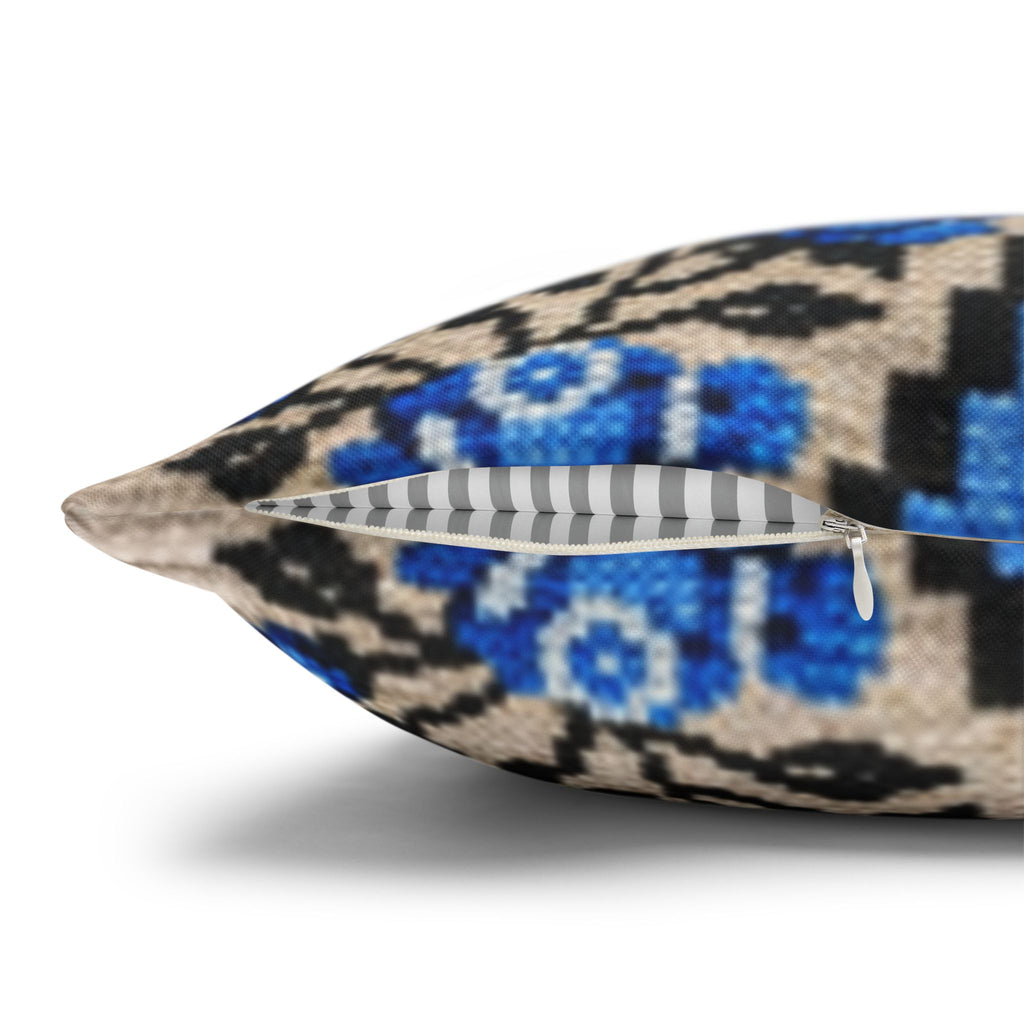 Ukrainian Berehynia throw pillow with blue black folk art pattern on sofa
