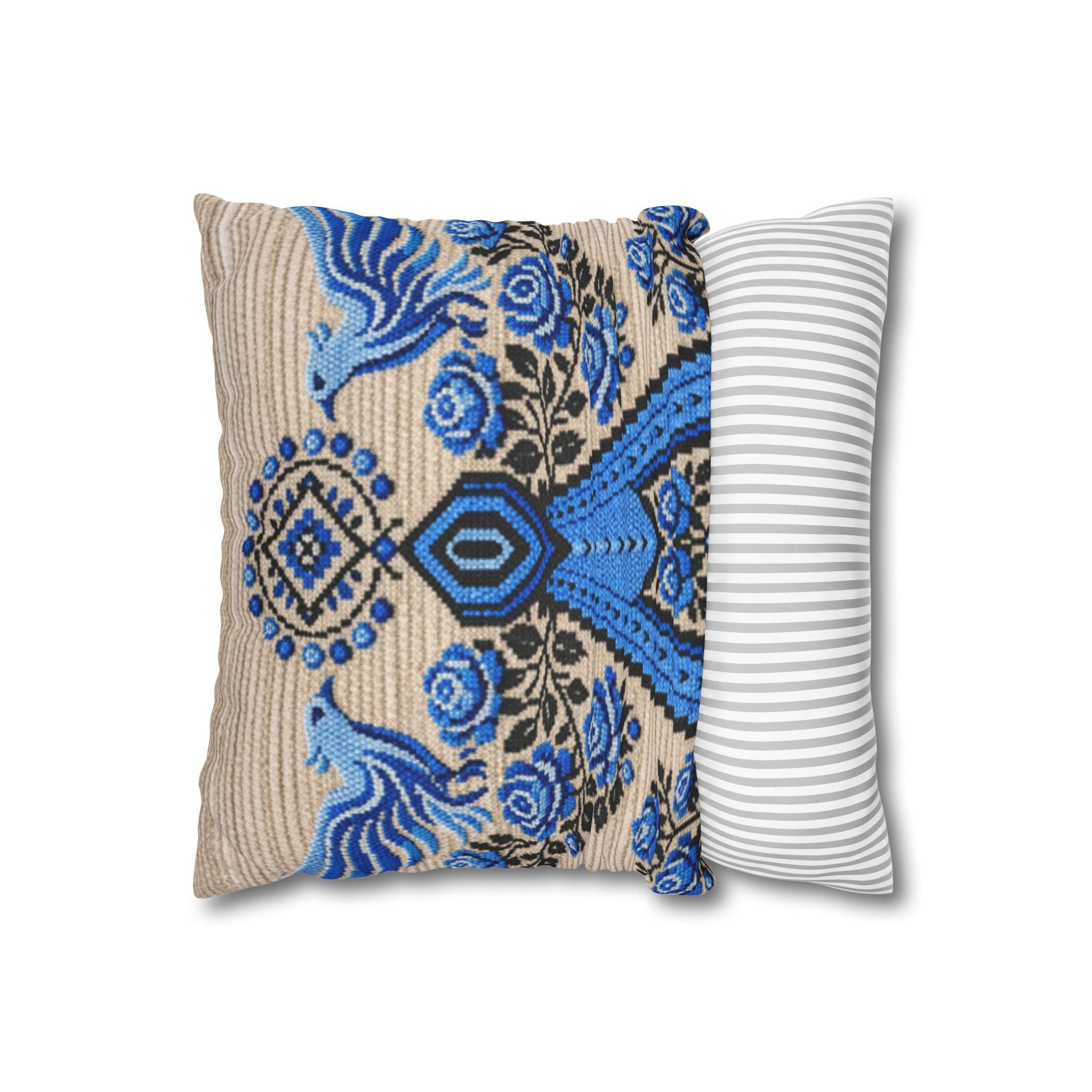 Ukrainian Berehynia throw pillow with blue black folk art pattern on sofa

