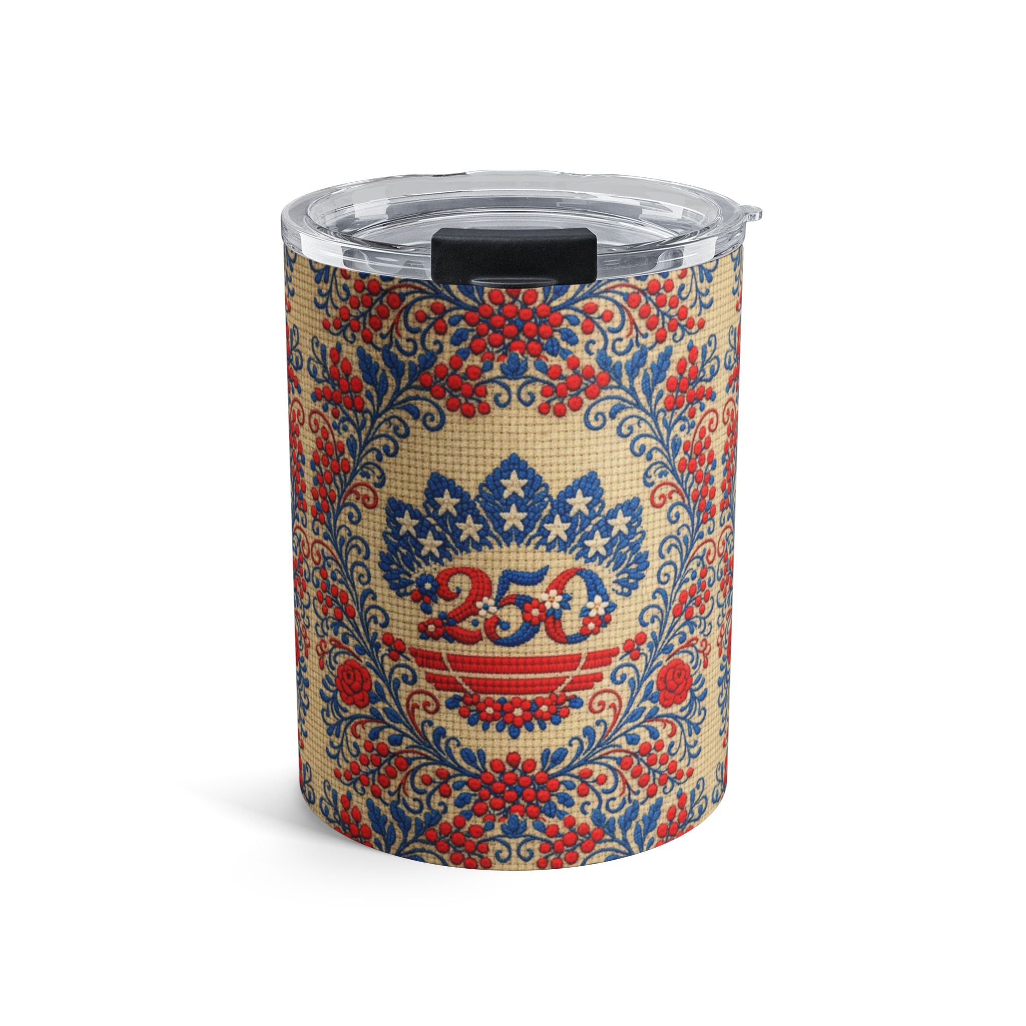 A 10oz stainless steel travel tumbler with a clear lid, featuring the "Freedom's Garden 250" design. The pattern displays a vintage-style red and blue 250 anniversary shield and floral folk art motifs on a soft cream-colored background.