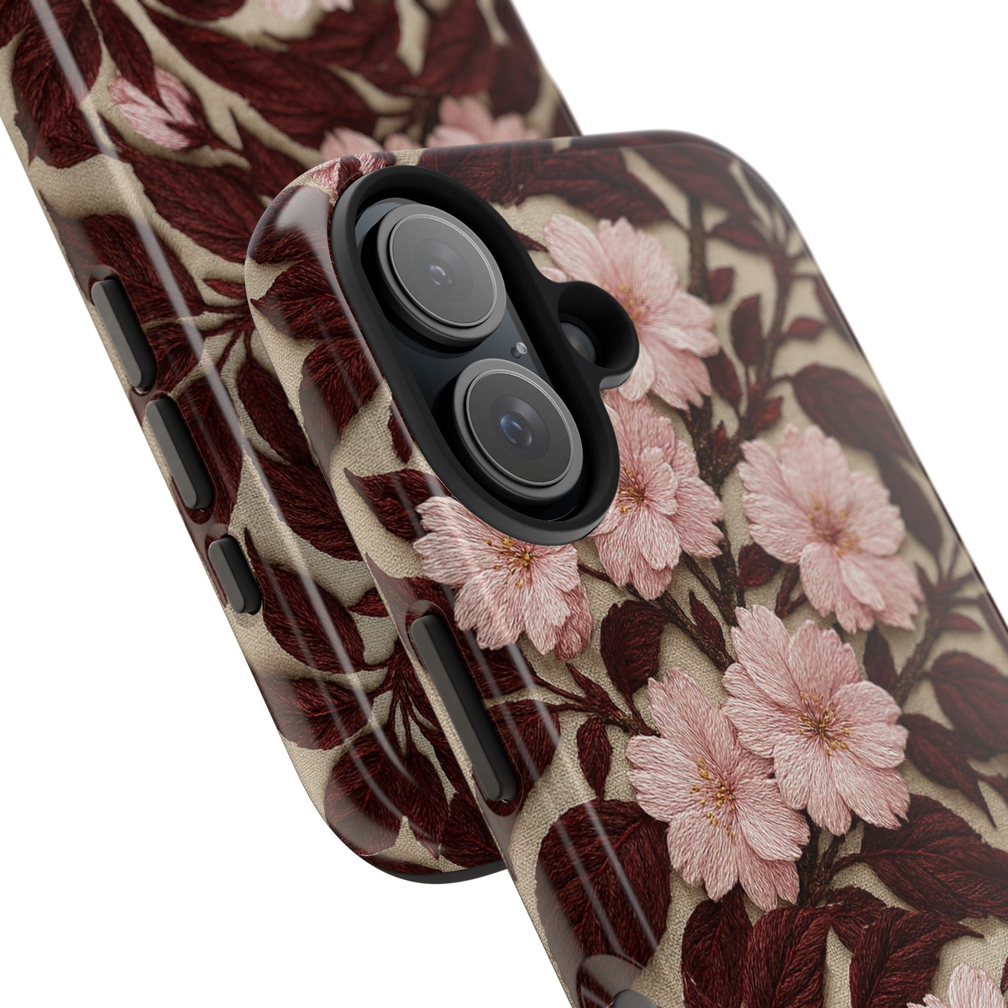 Close-up of a Sakura Noir tough phone case featuring a glossy vintage pink cherry blossom pattern with dark brown leaves and a black shock-absorbing liner.