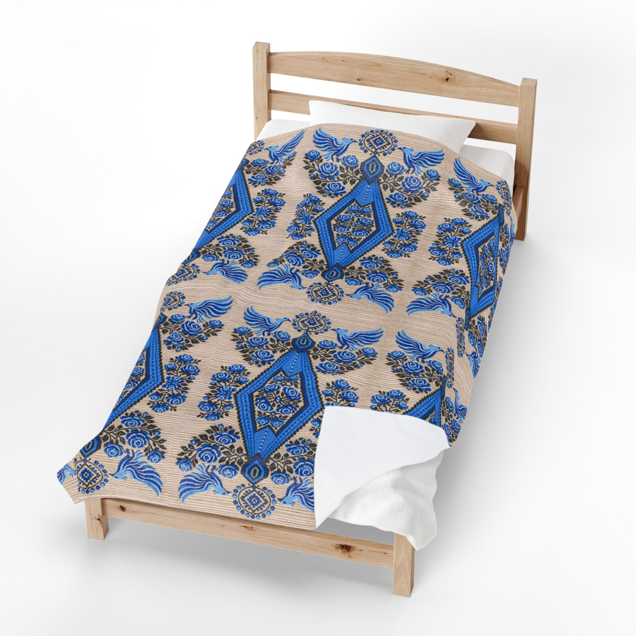 Ukrainian Berehynia blanket with blue black folk art geometric pattern on bed
