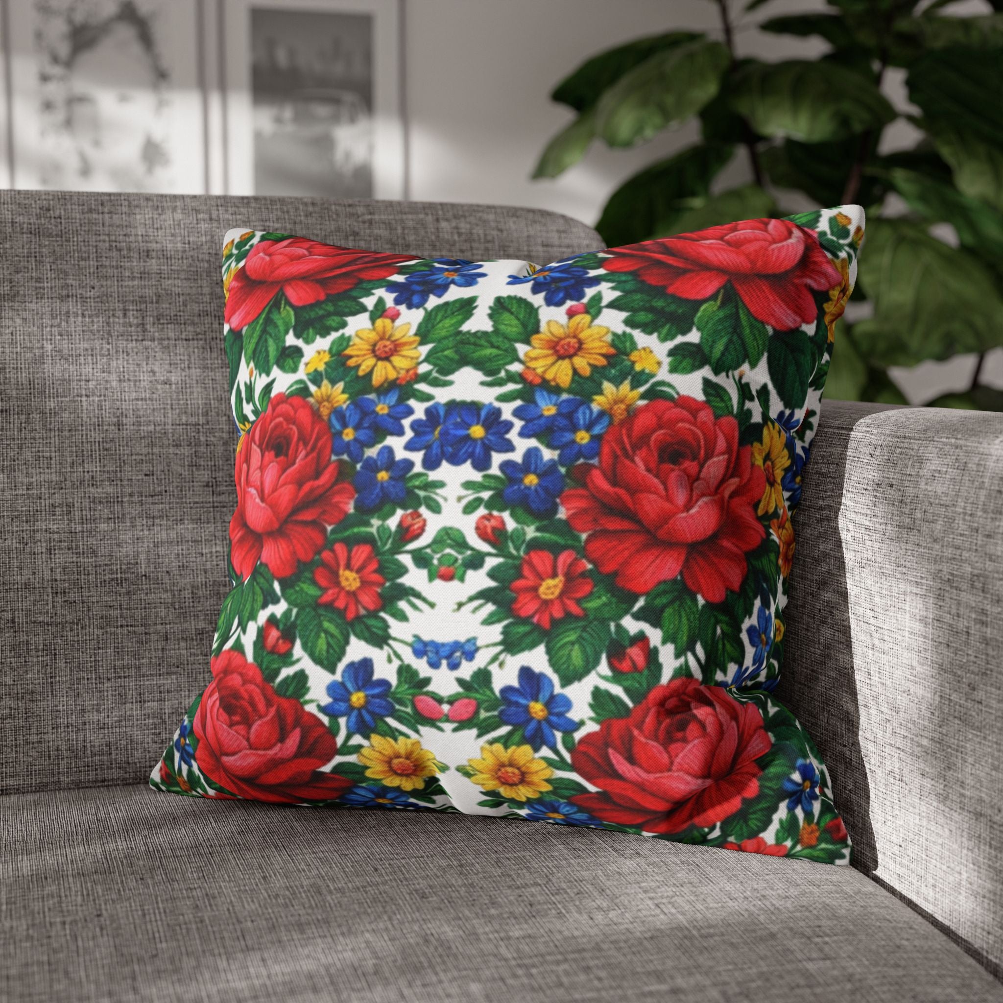 Square throw pillowcase featuring a bright, symmetrical pattern of large red roses, yellow daisies, and blue wildflowers on a white background.