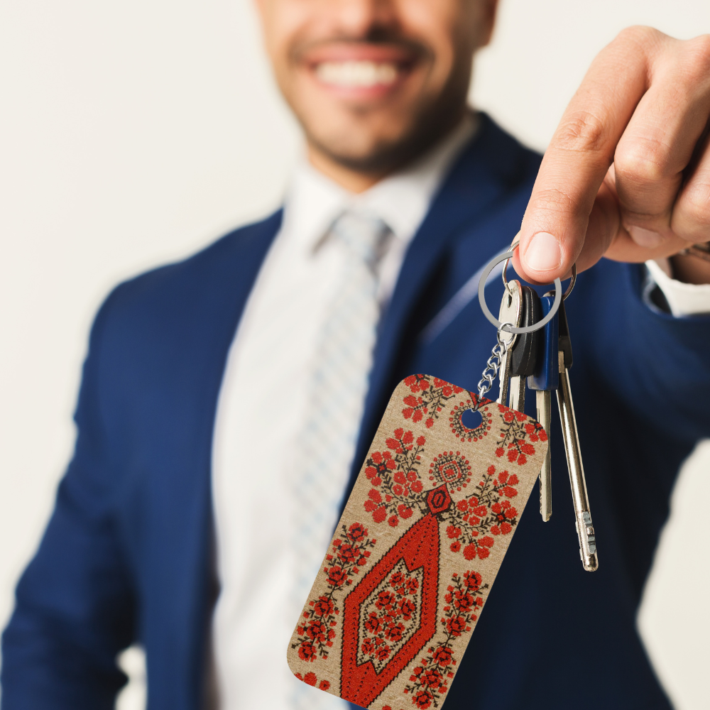 Ukrainian Berehynia keychain with red floral folk art pattern
