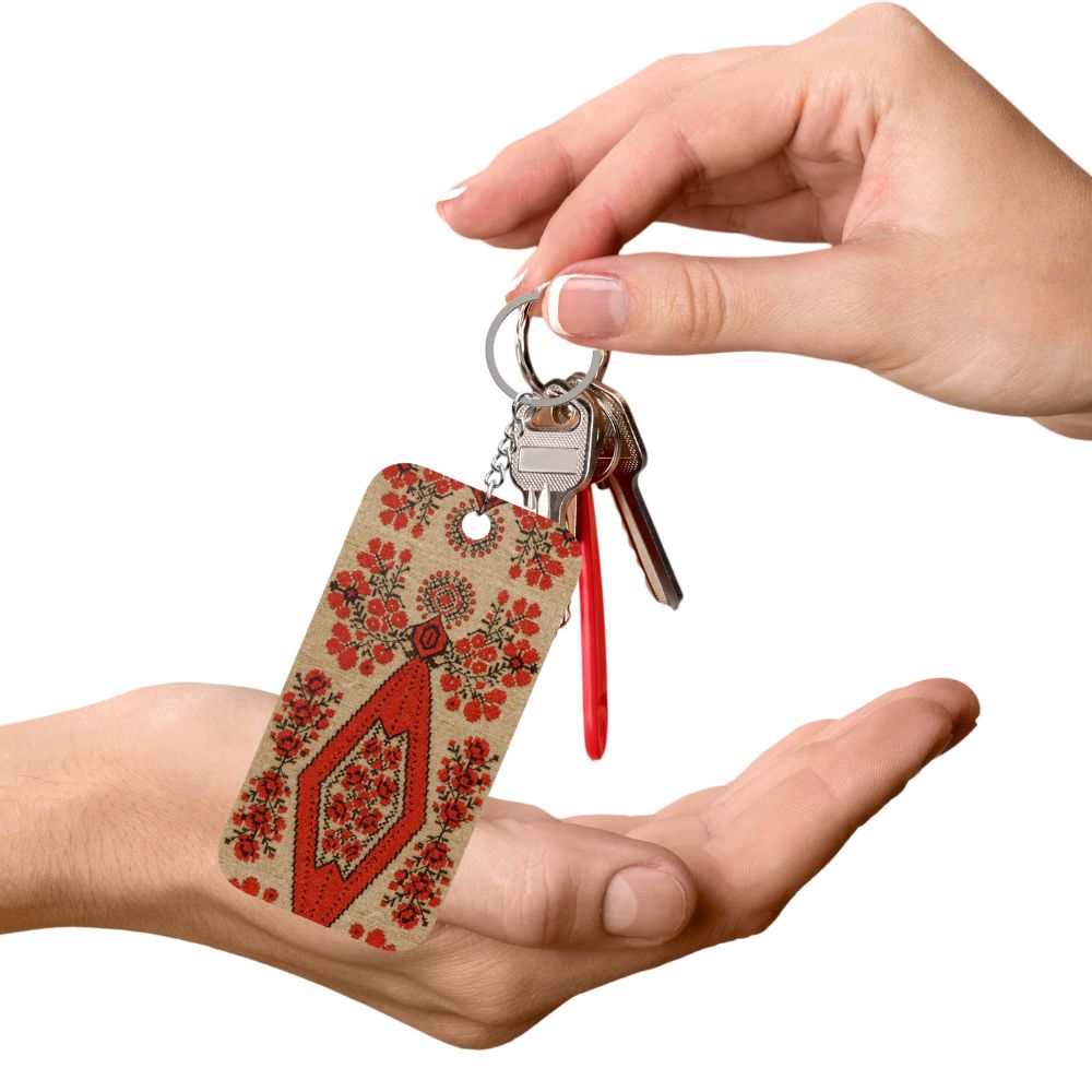 Ukrainian Berehynia keychain with red floral folk art pattern
