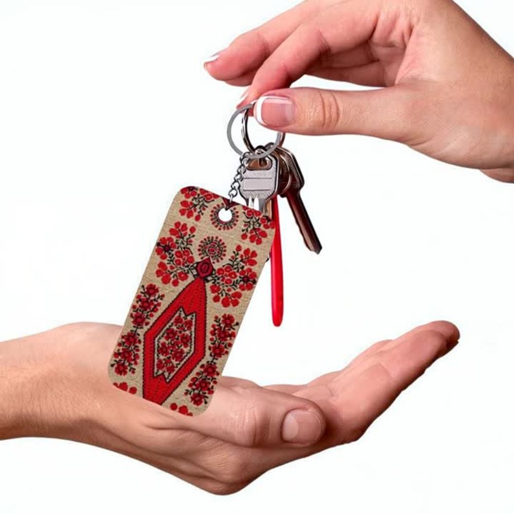 Ukrainian Berehynia keychain with red floral folk art pattern
