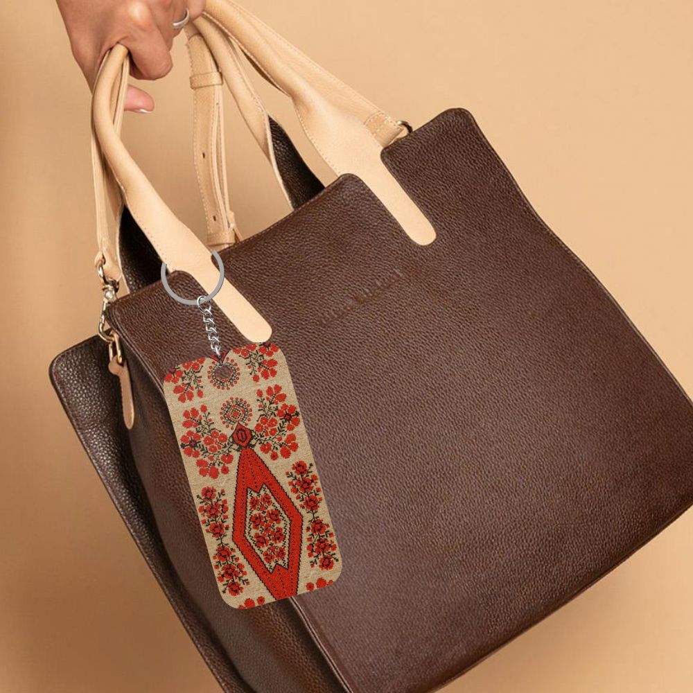 Ukrainian Berehynia keychain with red floral folk art pattern
