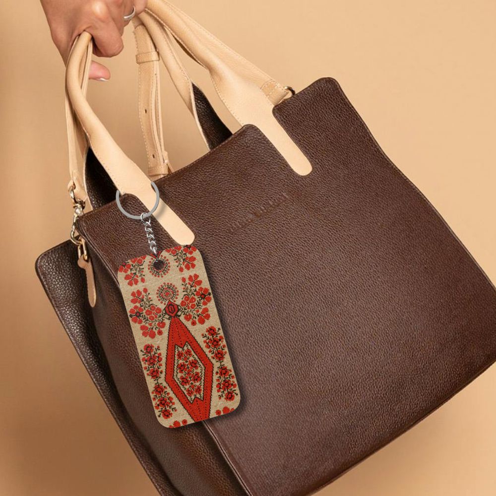 Ukrainian Berehynia keychain with red floral folk art pattern
