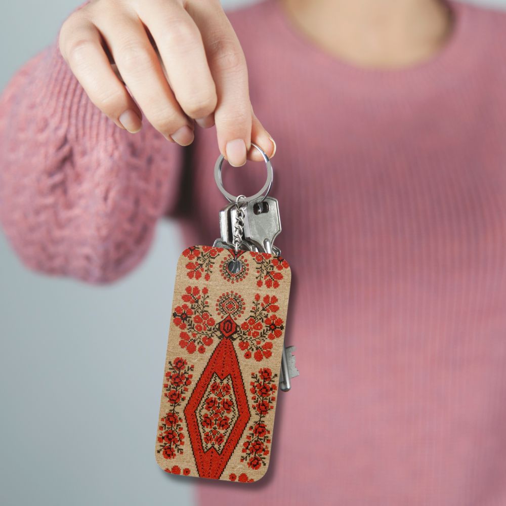Ukrainian Berehynia keychain with red floral folk art pattern
