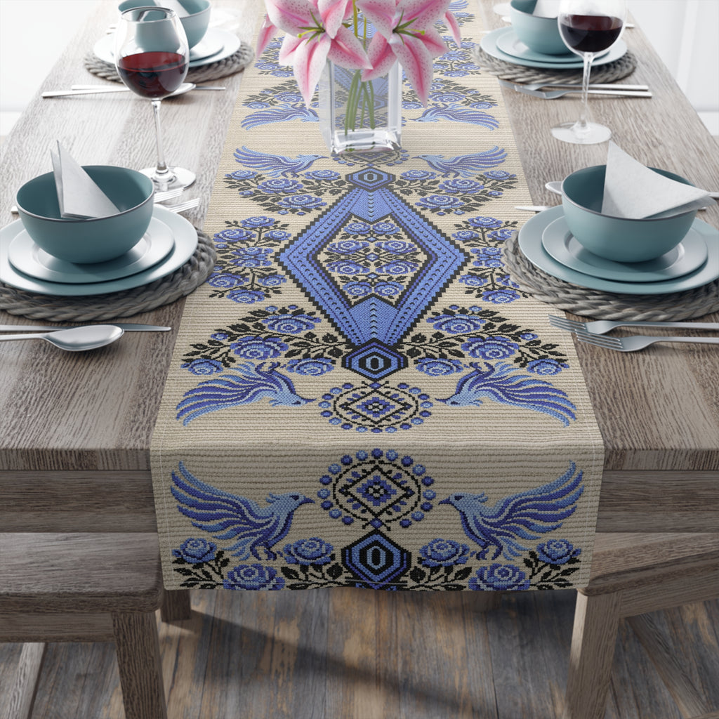 Ukrainian Berehynia table runner with blue black folk art pattern on dining table
