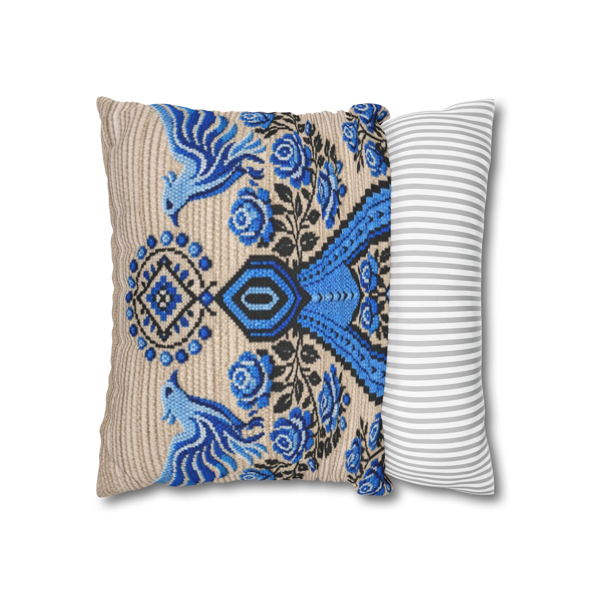 Ukrainian Berehynia throw pillow with blue black folk art pattern on sofa
