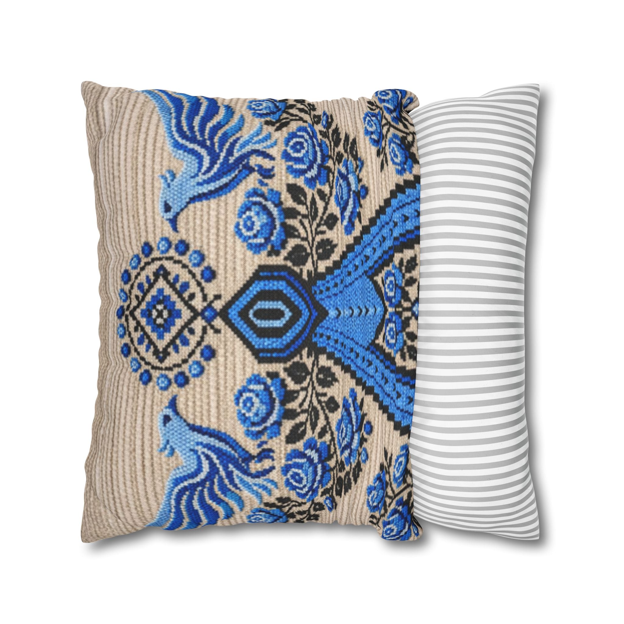 Ukrainian Berehynia throw pillow with blue black folk art pattern on sofa
