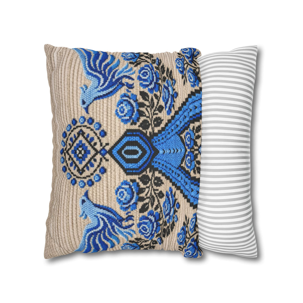 Ukrainian Berehynia throw pillow with blue black folk art pattern on sofa
