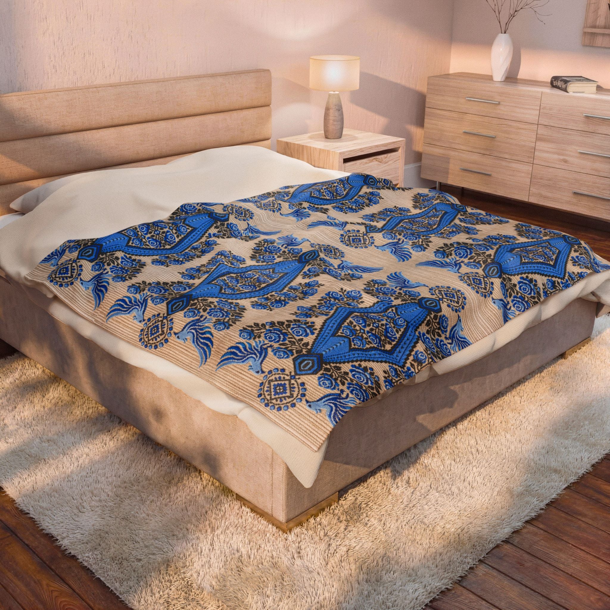 Ukrainian Berehynia blanket with blue black folk art geometric pattern on bed
