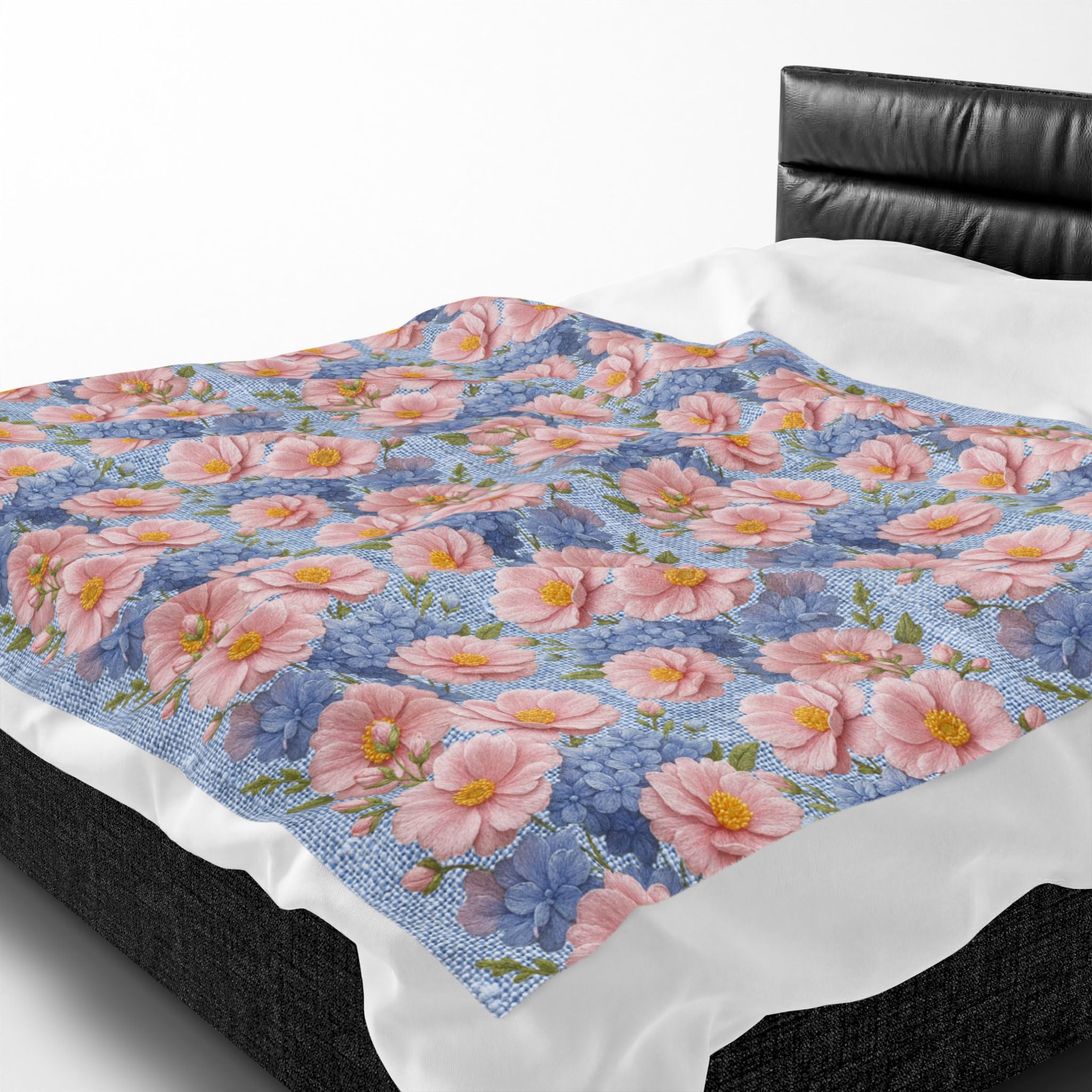 Velveteen plush blanket with a pink peony and blue hydrangea floral pattern draped over a white bed in the Soft Provence style.