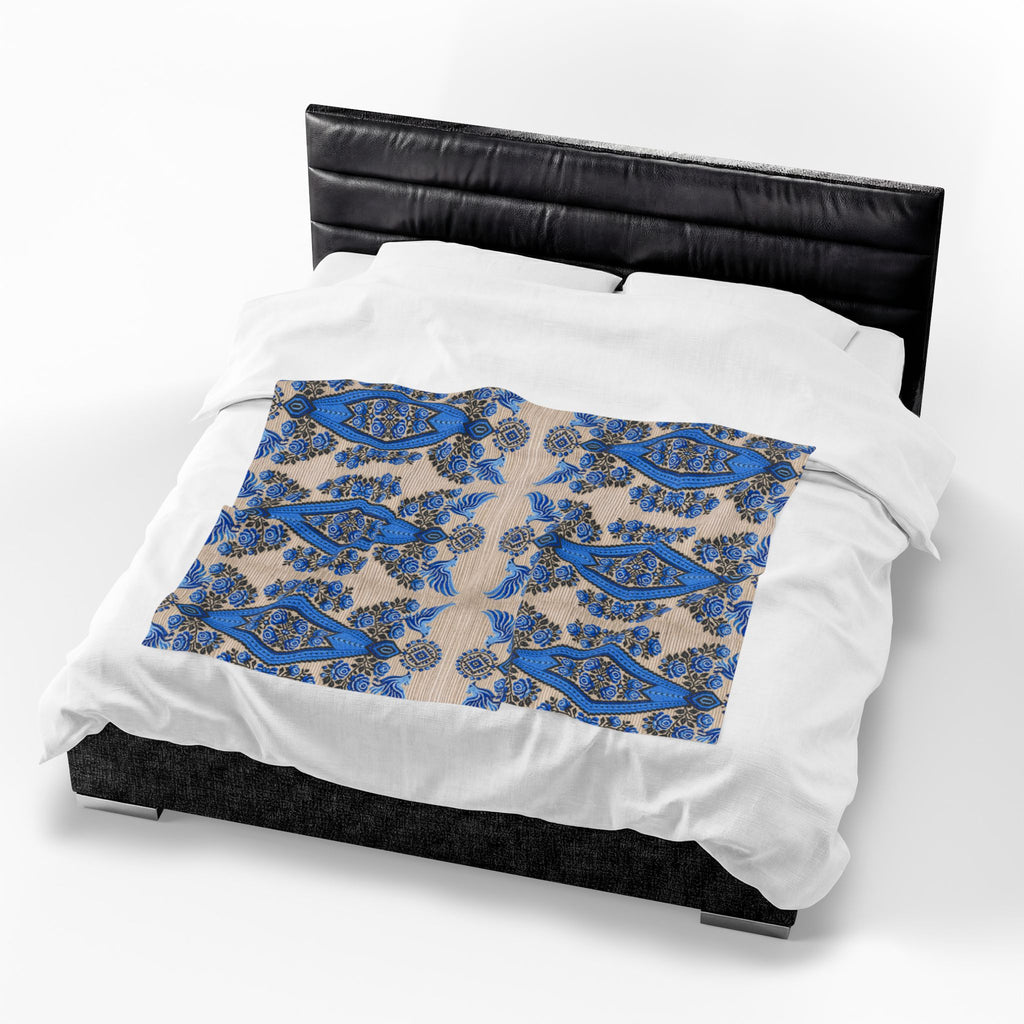 Ukrainian Berehynia blanket with blue black folk art geometric pattern on bed
