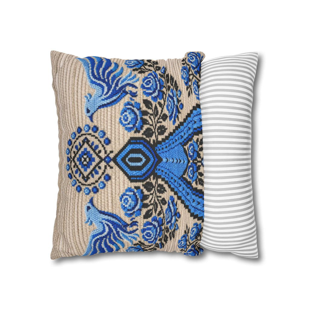 Ukrainian Berehynia throw pillow with blue black folk art pattern on sofa

