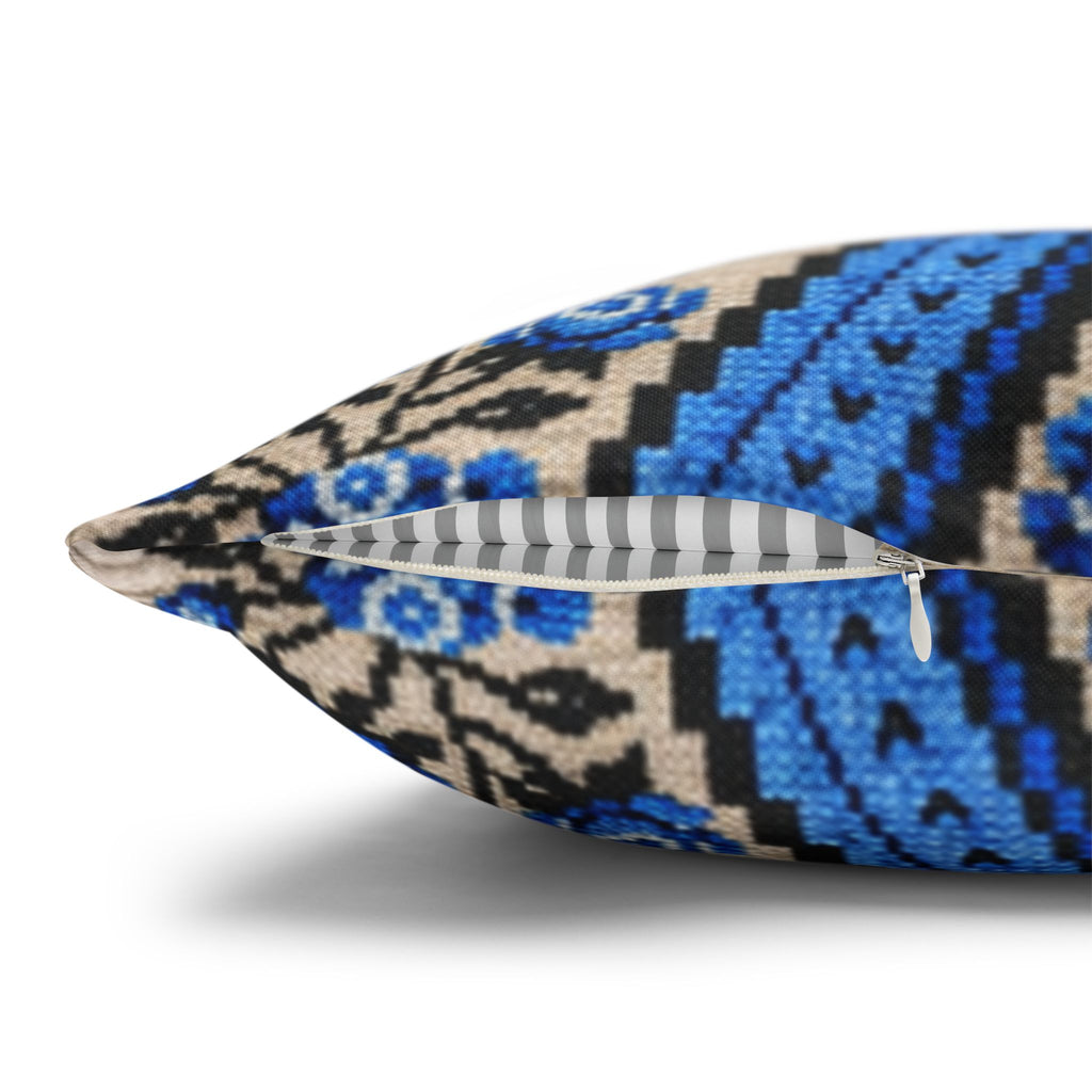 Ukrainian Berehynia throw pillow with blue black folk art pattern on sofa
