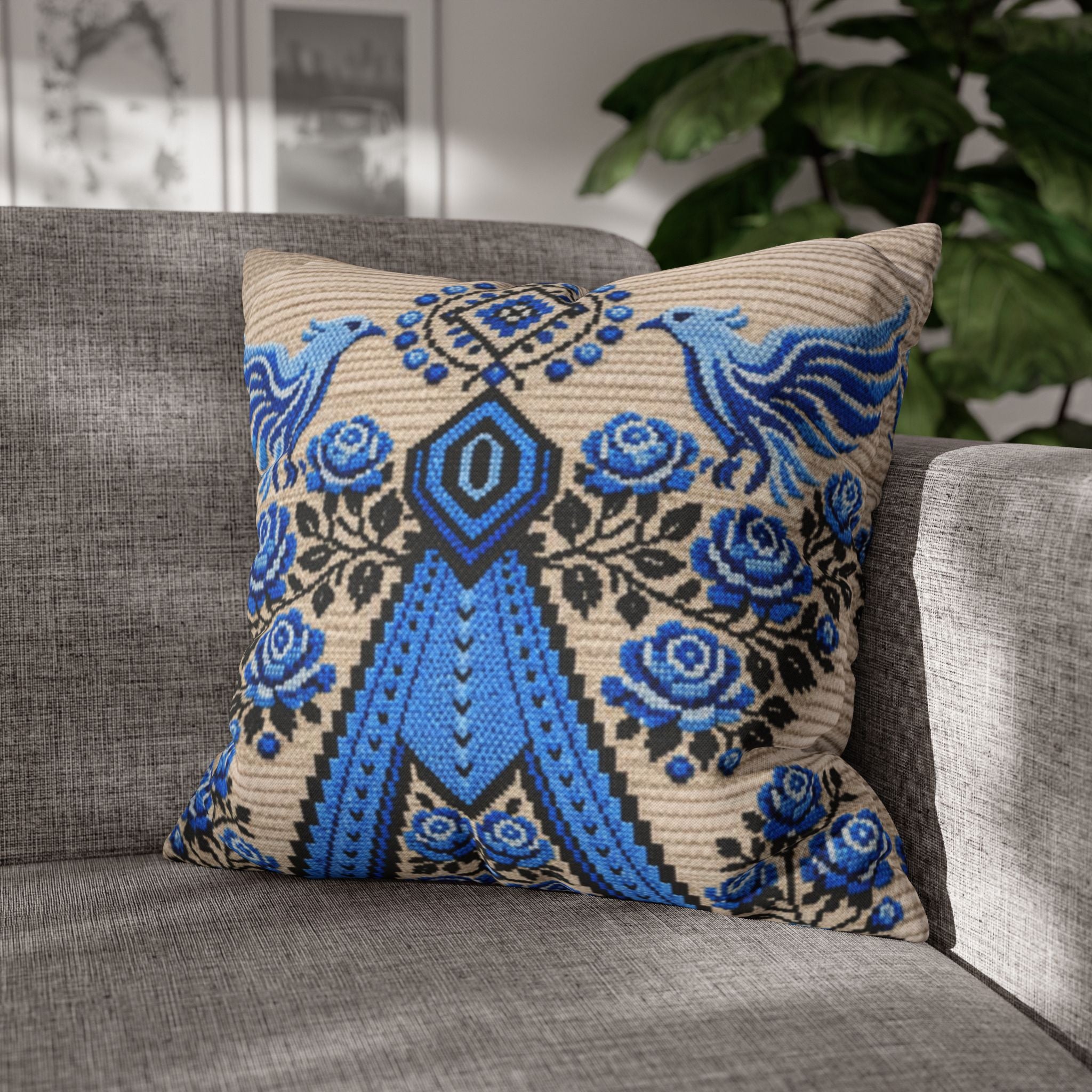 Ukrainian Berehynia throw pillow with blue black folk art pattern on sofa
