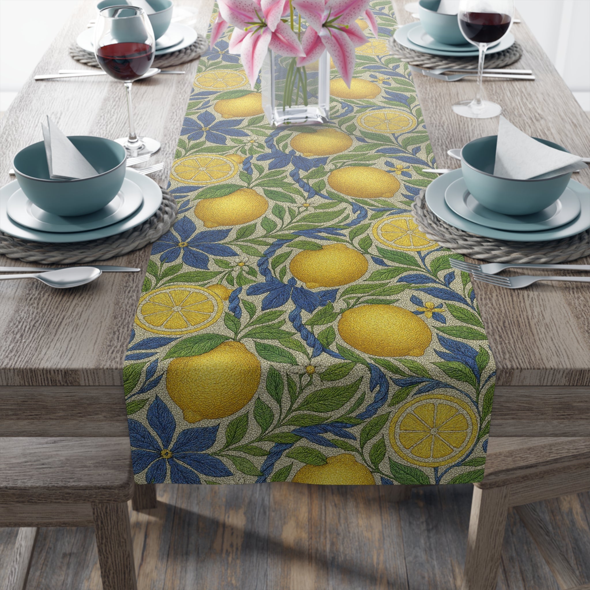 Close-up of a table runner with a lemon and blue flower pattern on a wooden table, featuring blue bowls and glasses of red wine.