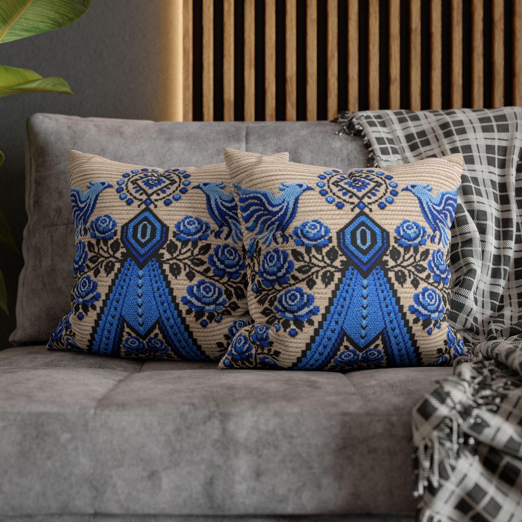 Ukrainian Berehynia throw pillow with blue black folk art pattern on sofa

