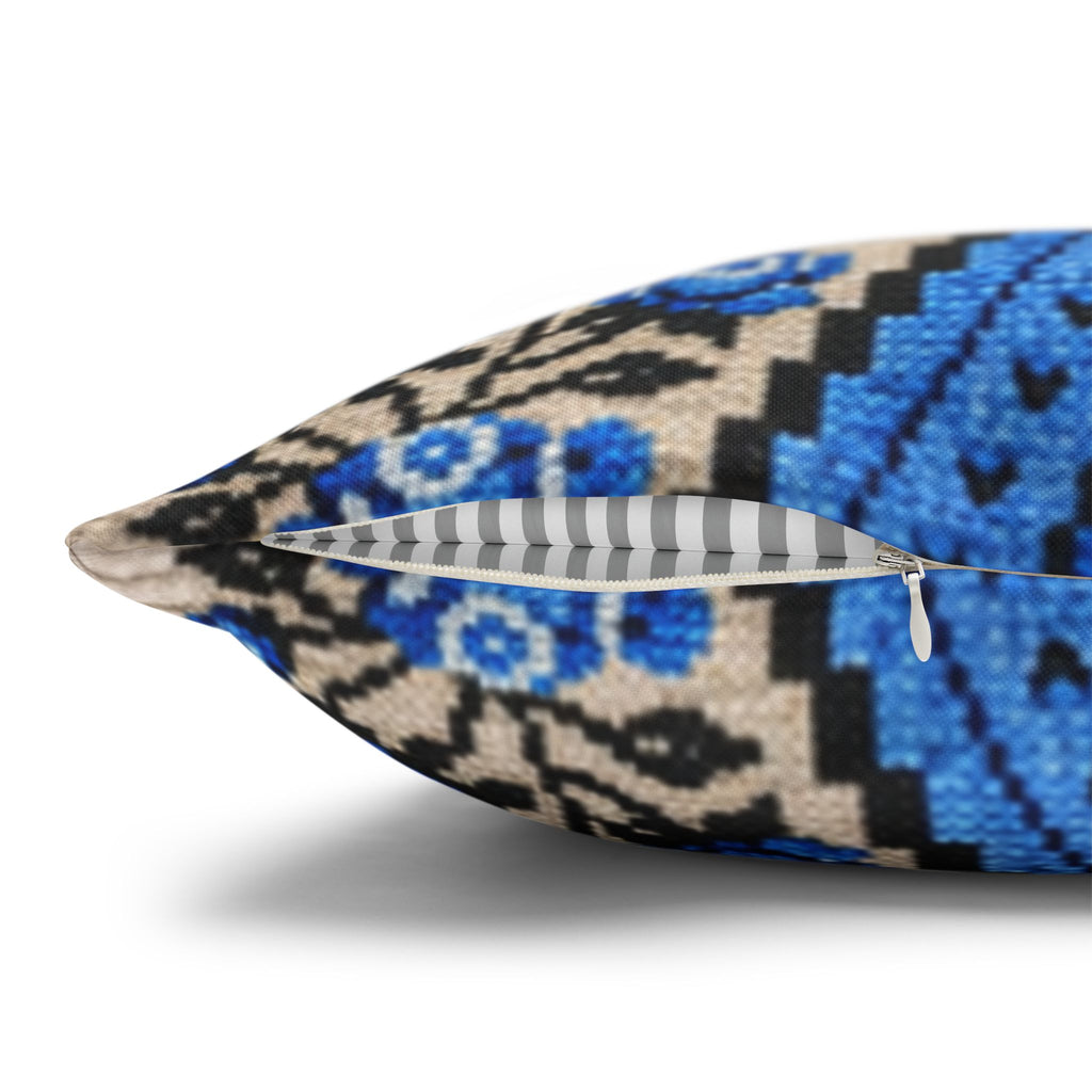 Ukrainian Berehynia throw pillow with blue black folk art pattern on sofa
