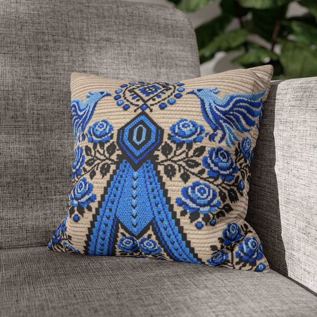 Ukrainian Berehynia throw pillow with blue black folk art pattern on sofa
