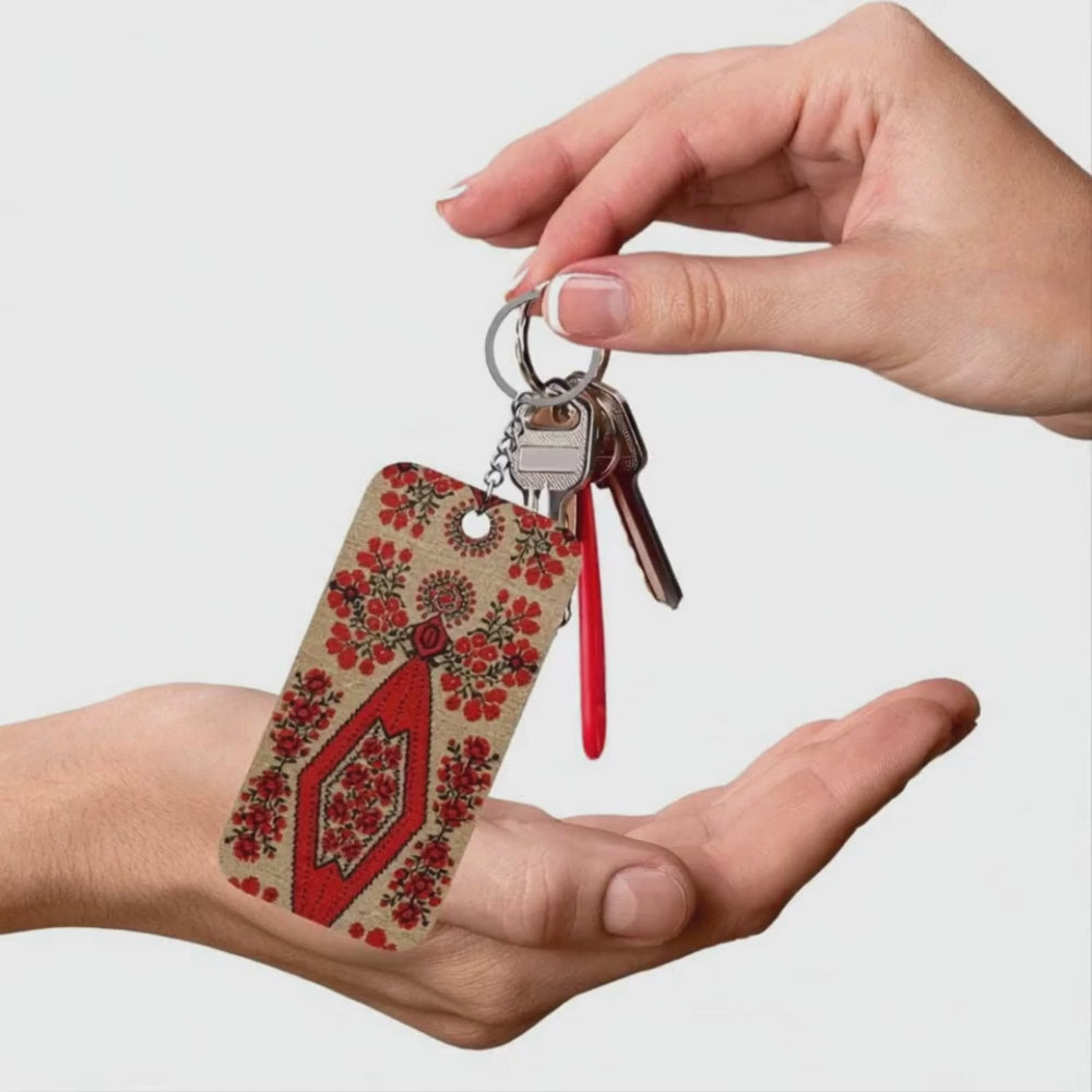 Ukrainian Berehynia keychain with red floral folk art pattern
